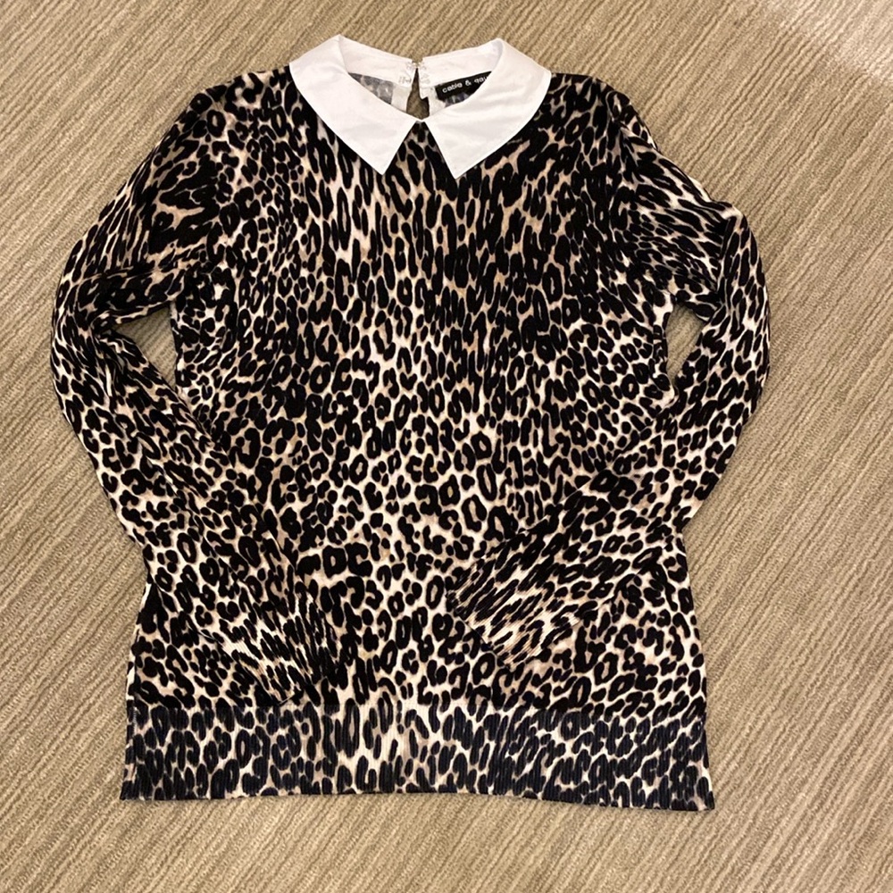 Animal print sweater with white collar.